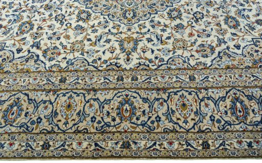 Corner detail of 2000s Kashan rug showing border pattern and Wool pile