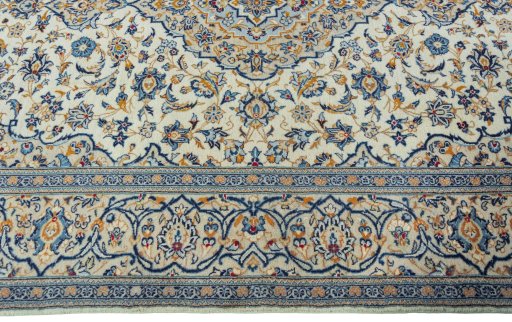 Corner detail of 2000s Kashan rug showing border pattern and Wool pile