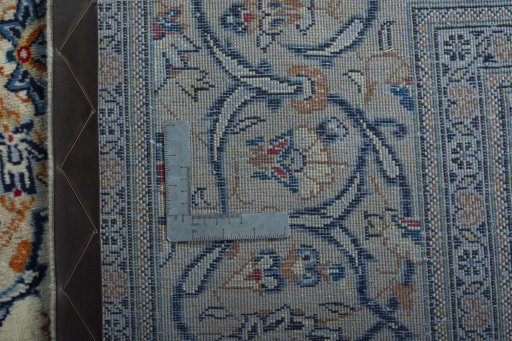 Backside of handmade 2000s Kashan rug showing knot structure and weave density