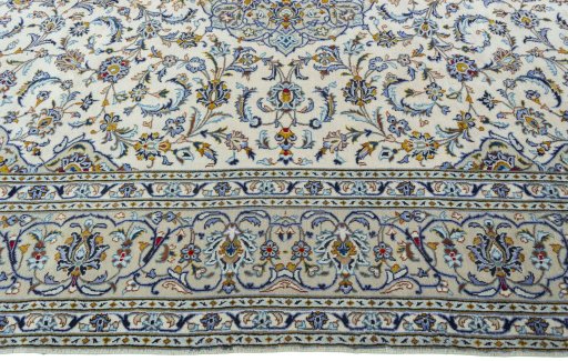 Corner detail of 2000s Kashan rug showing border pattern and Wool pile