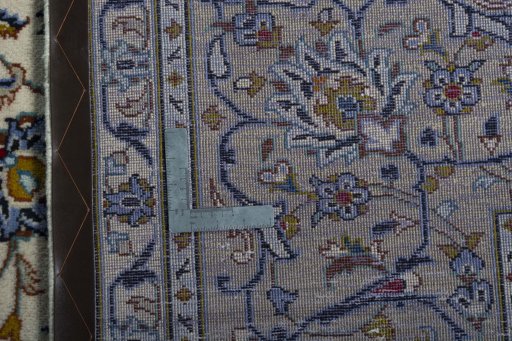 Backside of handmade 2000s Kashan rug showing knot structure and weave density