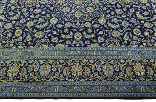 Corner detail of 2000s Kashan rug showing border pattern and Wool pile