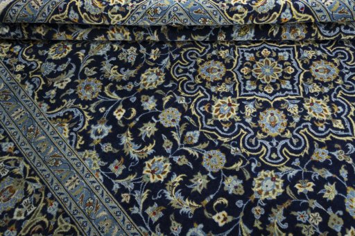 Close-up detail of 2000s Kashan rug from Iran / Persia showing Wool weave