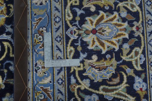 Backside of handmade 2000s Kashan rug showing knot structure and weave density