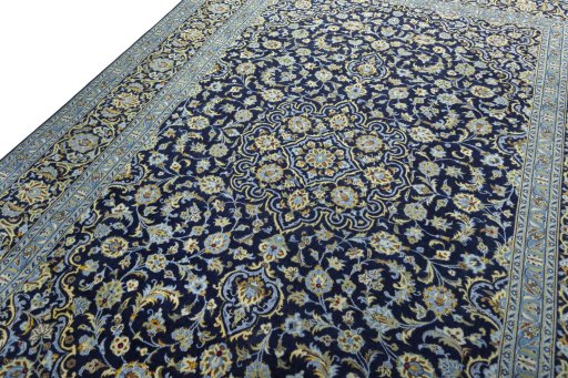 Backside of handmade 2000s Kashan rug showing knot structure and weave density
