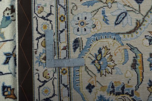 Backside of handmade 2000s Kashan rug showing knot structure and weave density