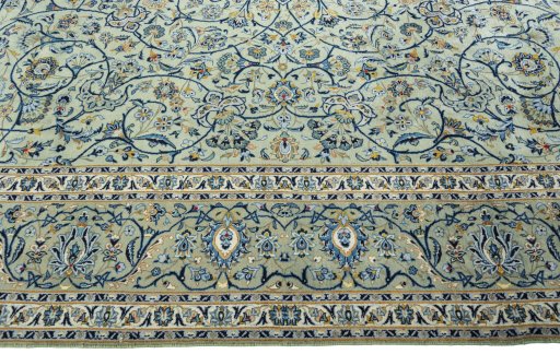 Corner detail of 2000s Kashan rug showing border pattern and Wool pile