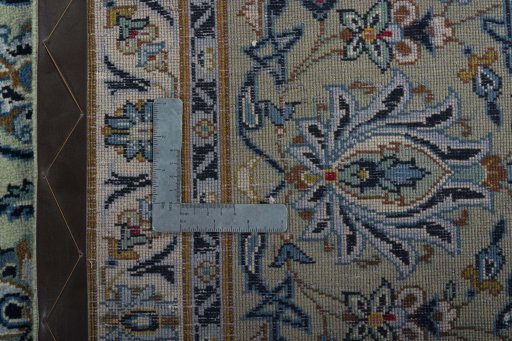 Backside of handmade 2000s Kashan rug showing knot structure and weave density
