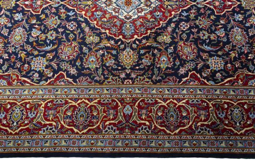 Corner detail of New Kashan rug showing border pattern and Cork pile