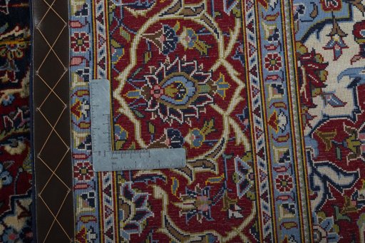 Backside of handmade New Kashan rug showing knot structure and weave density