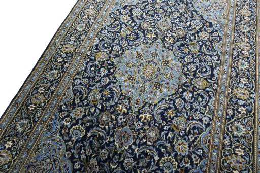 Backside of handmade New Kashan rug showing knot structure and weave density
