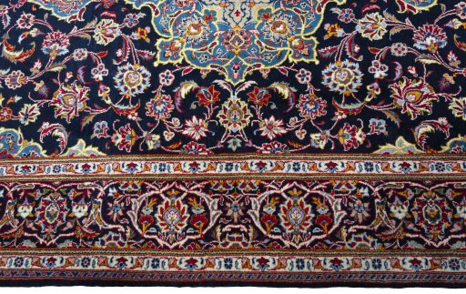 Corner detail of New Kashan rug showing border pattern and Cork pile