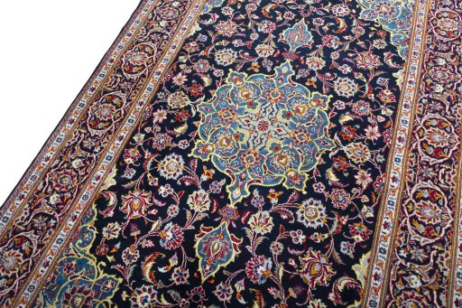 Backside of handmade New Kashan rug showing knot structure and weave density
