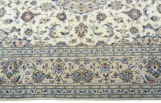 Corner detail of 2000s Kashan rug showing border pattern and Wool pile