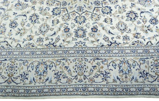Corner detail of 2000s Kashan rug showing border pattern and Wool pile