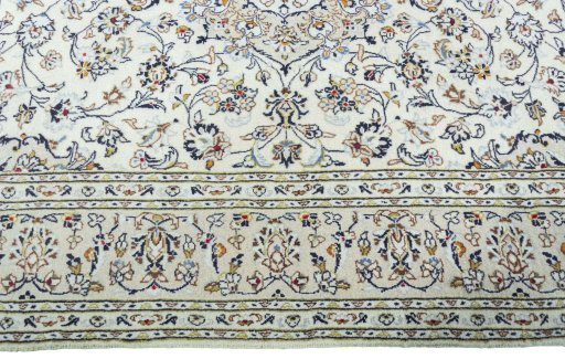 Corner detail of 2000s Kashan rug showing border pattern and Wool pile