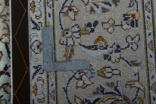 Backside of handmade 2000s Kashan rug showing knot structure and weave density