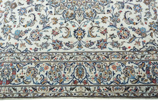 Corner detail of 2000s Kashan rug showing border pattern and Wool pile