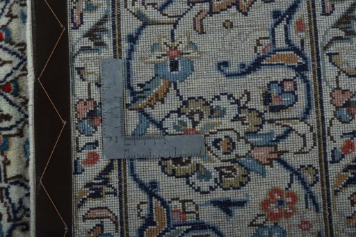 Backside of handmade 2000s Kashan rug showing knot structure and weave density