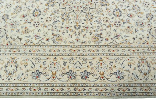 Corner detail of 2000s Kashan rug showing border pattern and Wool pile