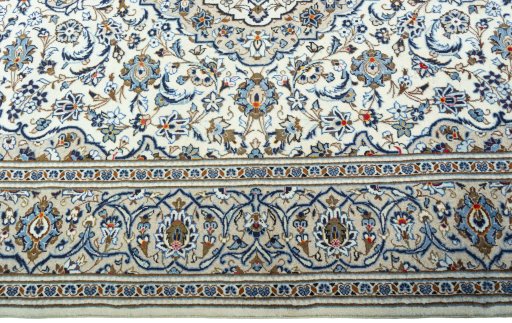 Corner detail of 2000s Kashan rug showing border pattern and Wool pile