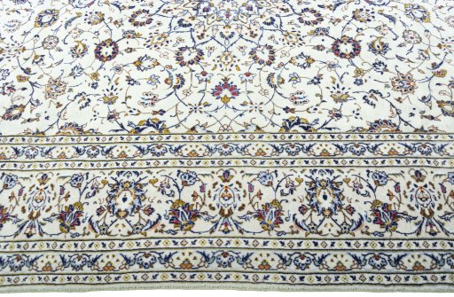 Corner detail of 2000s Kashan rug showing border pattern and Wool pile