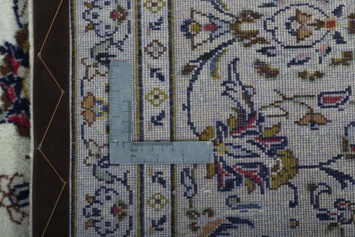 Backside of handmade 2000s Kashan rug showing knot structure and weave density