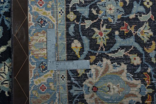 Backside of handmade 1970s Kashan rug showing knot structure and weave density