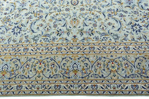 Corner detail of 2000s Kashan rug showing border pattern and Wool pile