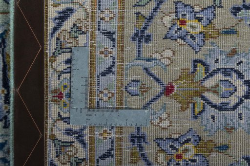 Backside of handmade 2000s Kashan rug showing knot structure and weave density