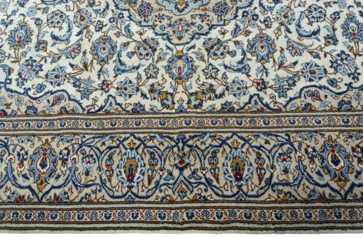 Corner detail of 2000s Kashan rug showing border pattern and Wool pile