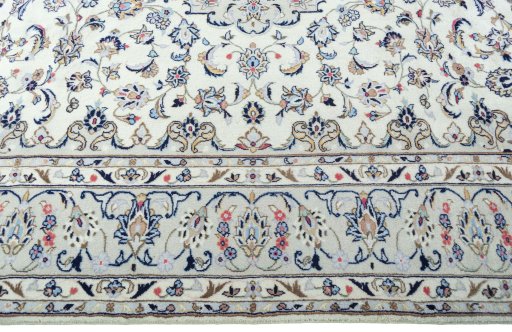 Corner detail of 2000s Kashan rug showing border pattern and Wool pile