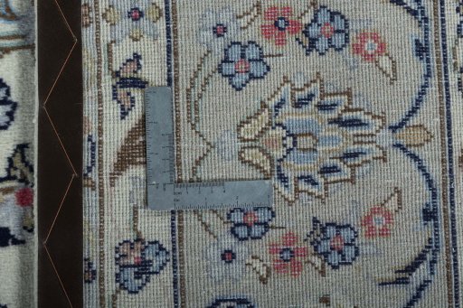 Backside of handmade 2000s Kashan rug showing knot structure and weave density