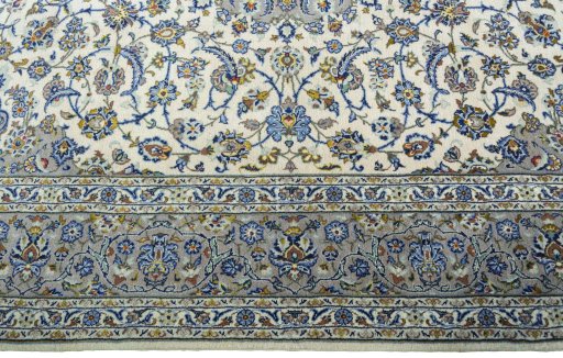 Corner detail of 2000s Kashan rug showing border pattern and Cork pile