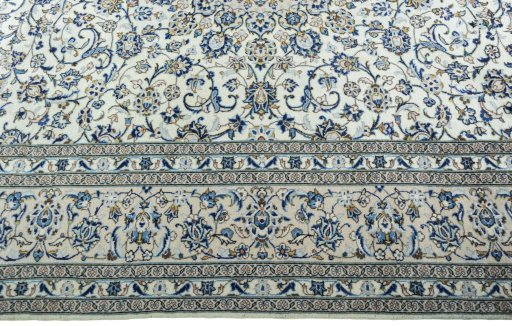 Corner detail of 2000s Kashan rug showing border pattern and Wool pile