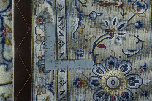 Backside of handmade 2000s Kashan rug showing knot structure and weave density