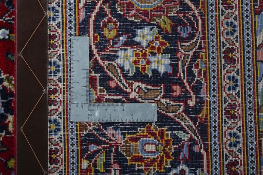 Backside of handmade New Kashan rug showing knot structure and weave density