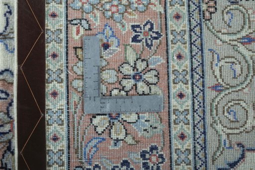 Backside of handmade New Kashan rug showing knot structure and weave density
