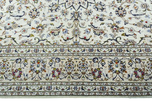 Corner detail of 2000s Kashan rug showing border pattern and Wool pile