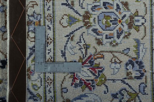 Backside of handmade 2000s Kashan rug showing knot structure and weave density