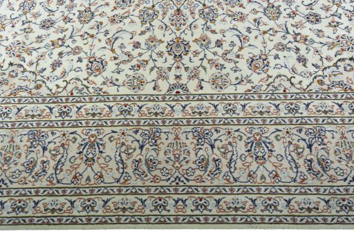 Corner detail of 2000s Kashan rug showing border pattern and Wool pile