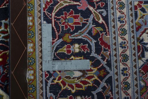 Backside of handmade New Kashan rug showing knot structure and weave density