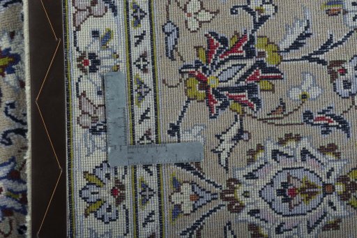 Backside of handmade New Kashan rug showing knot structure and weave density