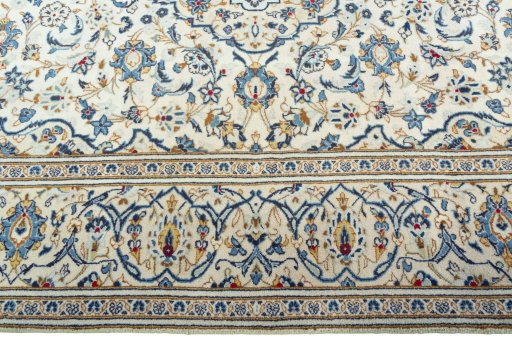 Corner detail of 2000s Kashan rug showing border pattern and Wool pile