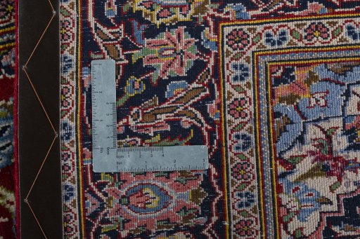 Backside of handmade 2000s Kashan rug showing knot structure and weave density
