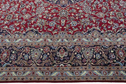 Corner detail of 2000s Kashan rug showing border pattern and Wool pile