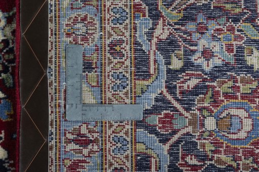 Backside of handmade 2000s Kashan rug showing knot structure and weave density