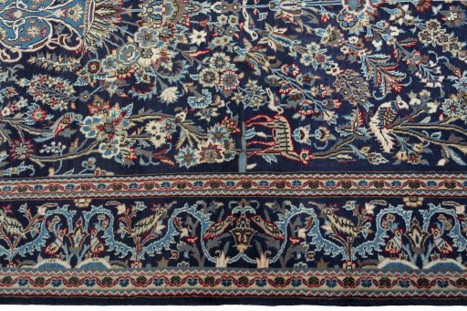Corner detail of 2000s Kashan rug showing border pattern and Wool pile