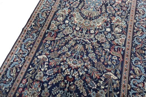 Backside of handmade 2000s Kashan rug showing knot structure and weave density
