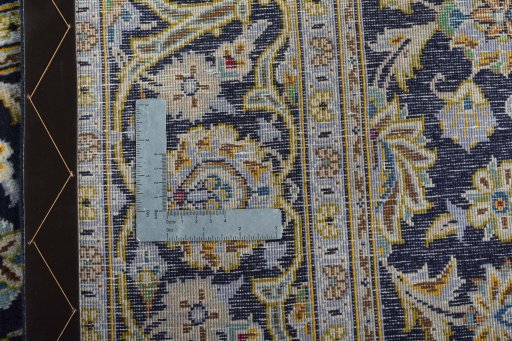Backside of handmade 1970s Kashan rug showing knot structure and weave density
